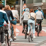 Image of a group of cyclists crossing at a street junction.