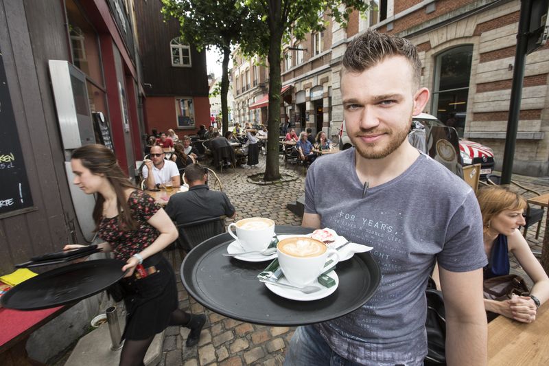 Waiter at coffee shop in pedestrian area