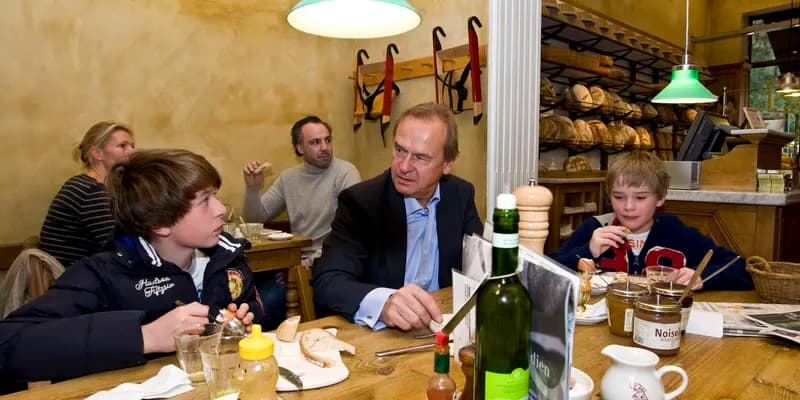 Father and sons having breakfast in coffee shop