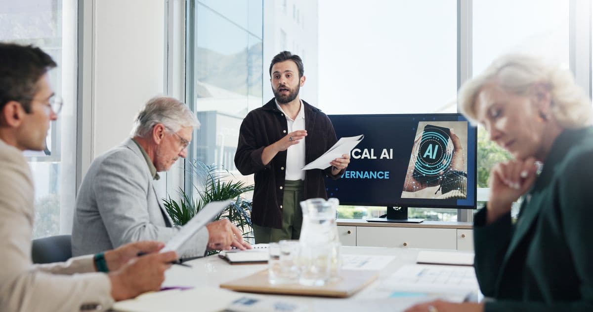 Man explaining artificial intelligence in a meeting with three other colleagues