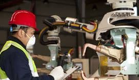 Technican checking robot machine