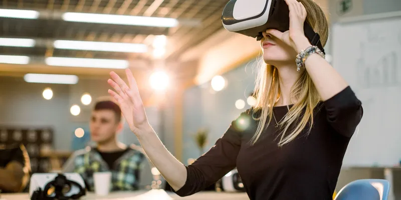 Woman using VR headset in office