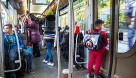 People standing and sitting on public transport