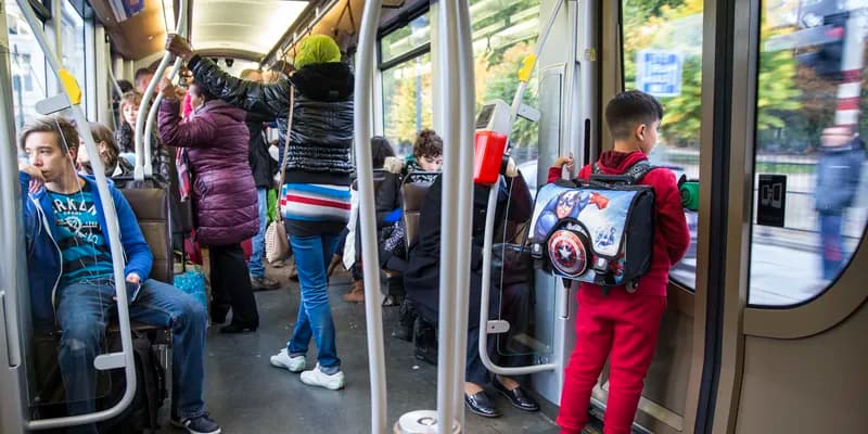 People standing and sitting on public transport