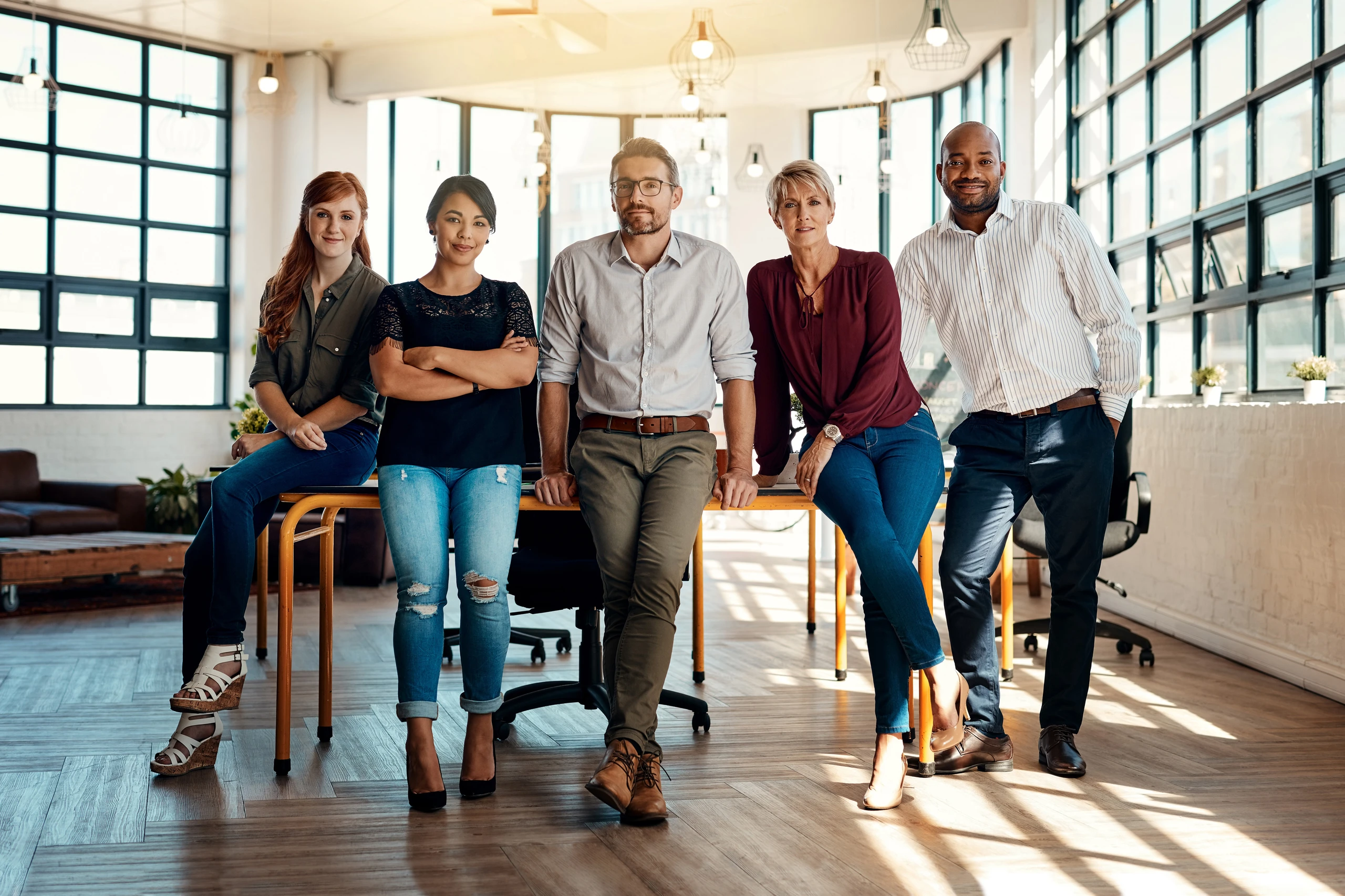 Team of five business people in office environment - SometimesNever/peopleimages.com / Adobe Stock