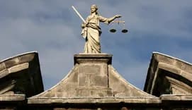 Statue Themis Goddess of justice on top of court building