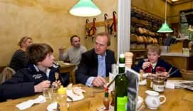 Father and sons having breakfast in coffee shop