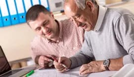Two architects drawing at table