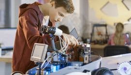 Apprentice working in computer factory