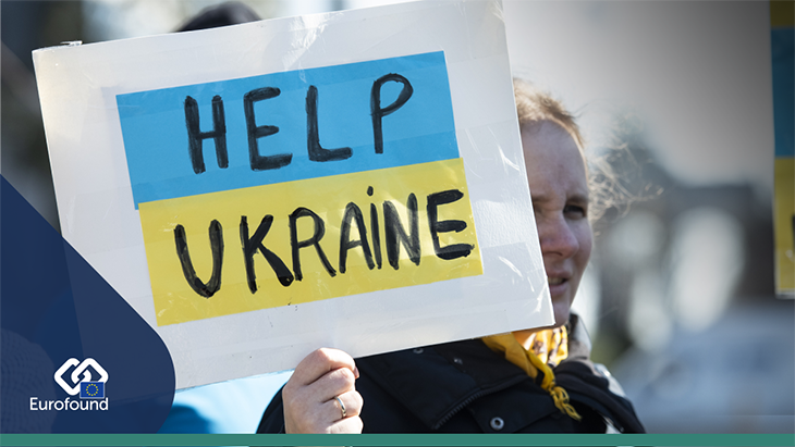 Image of female refugee holding a sign saying 'Help Ukraine'